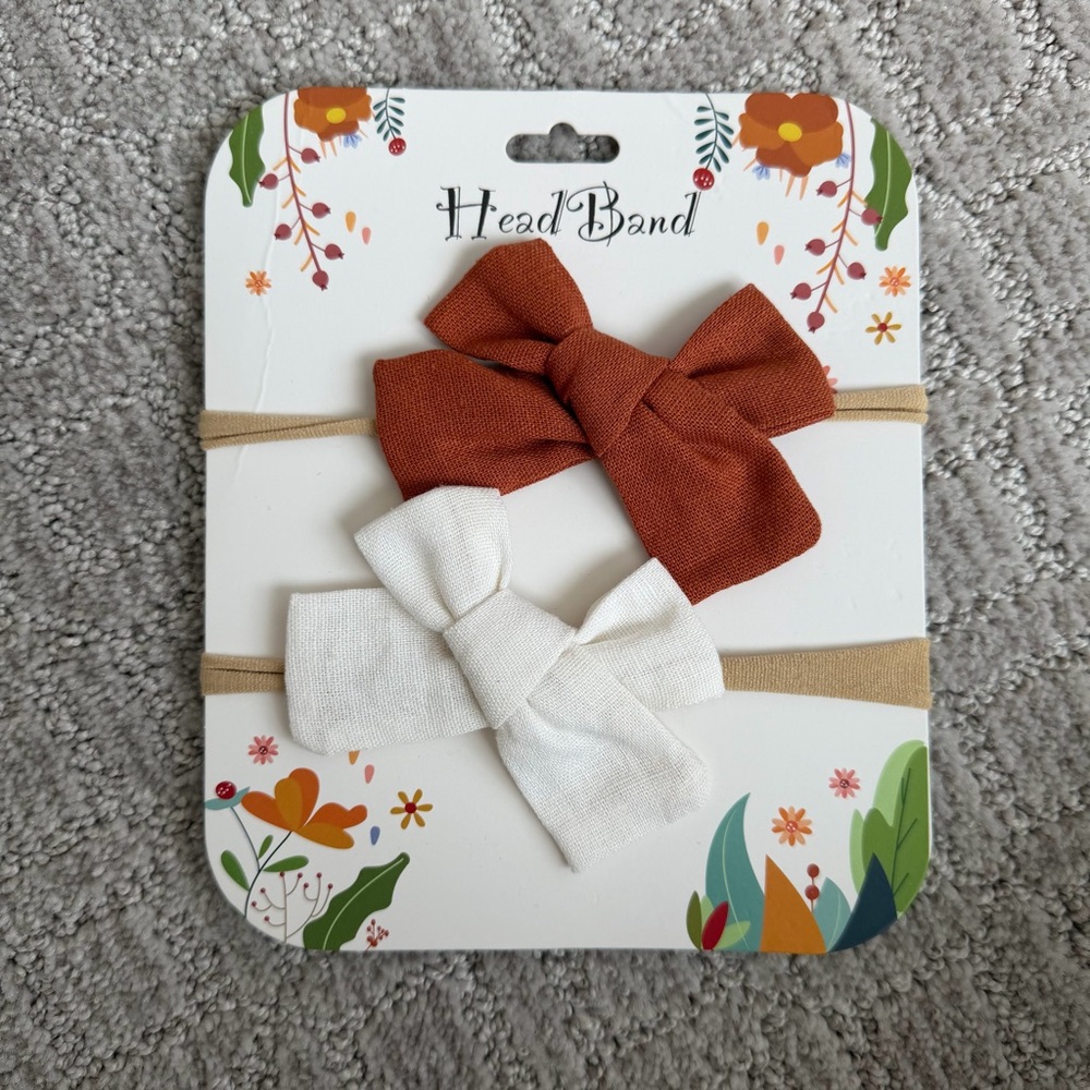 2 new Baby girl bows on nylon headbands